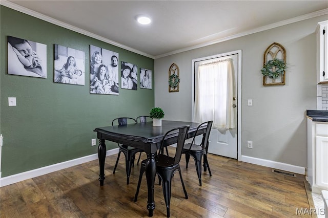 108 Karen St, Sikeston, MO 63801 - dining room featuring ornamental molding, dark wood-type flooring, and baseboards