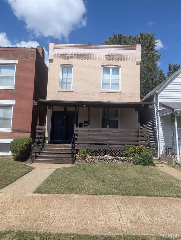 5257 Theodosia Ave, Saint Louis, MO 63113 - view of front of house with a porch and a front yard