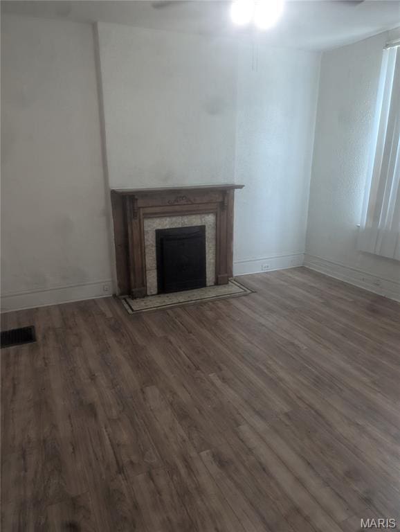 5257 Theodosia Ave, Saint Louis, MO 63113 - unfurnished living room featuring wood finished floors, baseboards, a fireplace, and a ceiling fan