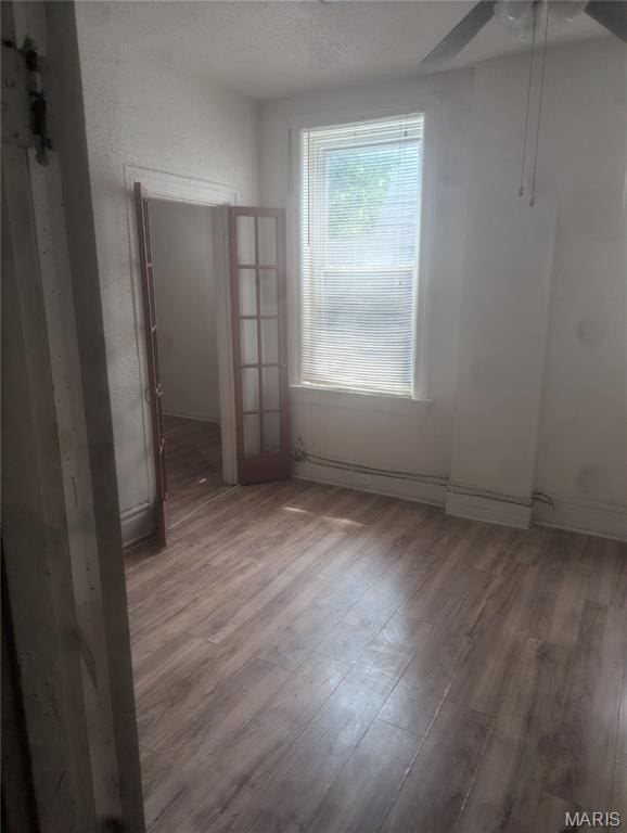 5257 Theodosia Ave, Saint Louis, MO 63113 - unfurnished room featuring wood finished floors and ceiling fan
