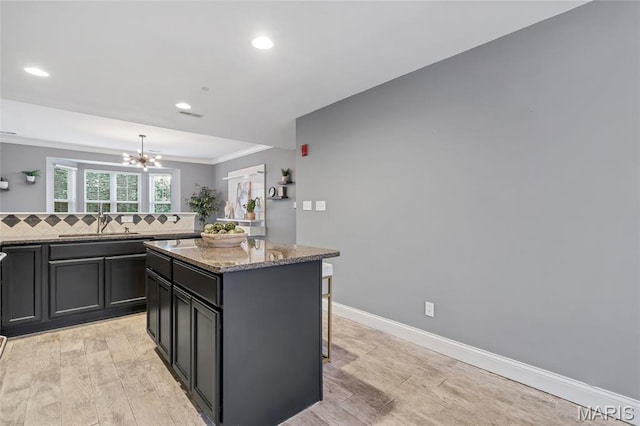 231 W Monroe Ave Unit 205, Saint Louis, MO 63122 - kitchen featuring ornamental molding, a chandelier, recessed lighting, a center island, and a kitchen bar