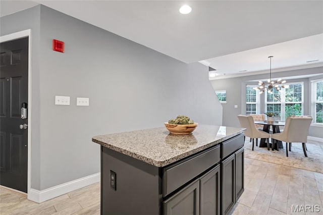 231 W Monroe Ave Unit 205, Saint Louis, MO 63122 - kitchen with light wood-style flooring, a chandelier, a kitchen island, decorative light fixtures, and recessed lighting