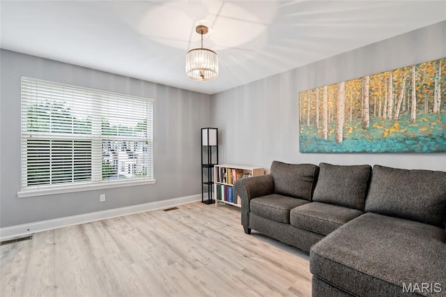 231 W Monroe Ave Unit 205, Saint Louis, MO 63122 - living area featuring a chandelier and wood finished floors