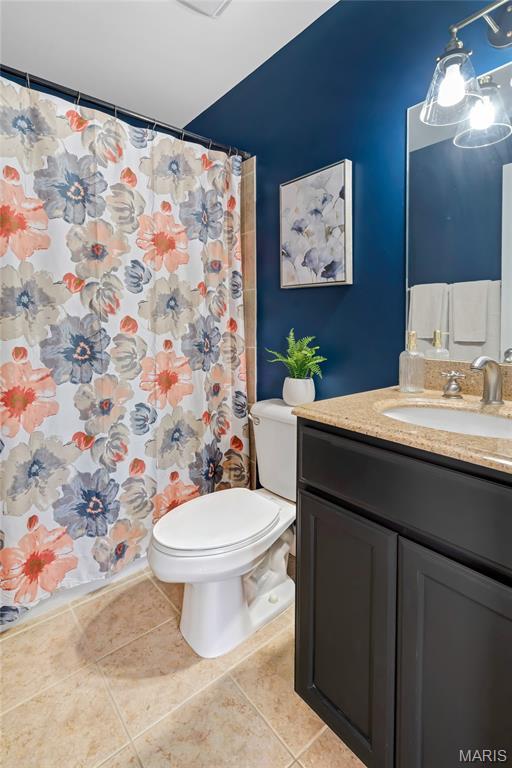 231 W Monroe Ave Unit 205, Saint Louis, MO 63122 - full bath featuring vanity, tile patterned floors, and a shower with curtain