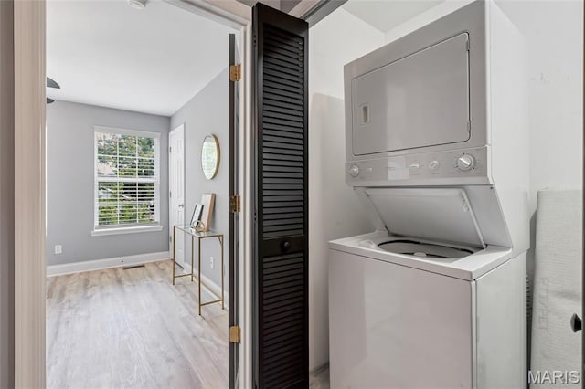 231 W Monroe Ave Unit 205, Saint Louis, MO 63122 - washroom featuring estacked washer and dryer and wood finished floors