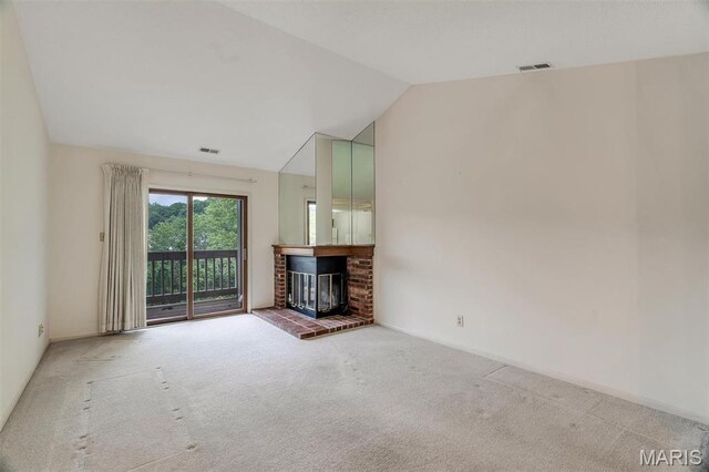 2303 Yosemite Park Ct Unit E, Maryland Heights, MO 63043 - unfurnished living room featuring carpet floors, vaulted ceiling, and a fireplace