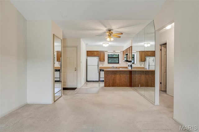 2303 Yosemite Park Ct Unit E, Maryland Heights, MO 63043 - kitchen with freestanding refrigerator, brown cabinets, a peninsula, and ceiling fan