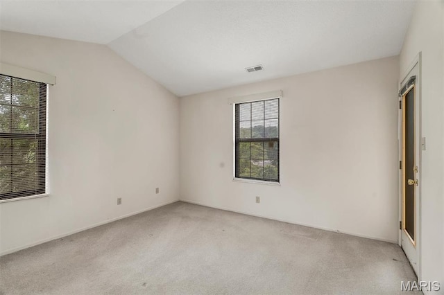 2303 Yosemite Park Ct Unit E, Maryland Heights, MO 63043 - unfurnished room with plenty of natural light, lofted ceiling, and light carpet