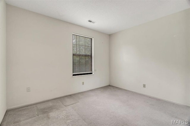 2303 Yosemite Park Ct Unit E, Maryland Heights, MO 63043 - empty room with carpet flooring and a textured ceiling