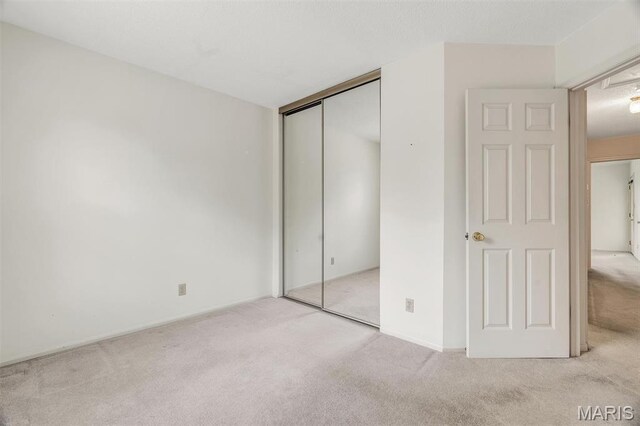 2303 Yosemite Park Ct Unit E, Maryland Heights, MO 63043 - unfurnished bedroom with carpet flooring and a closet