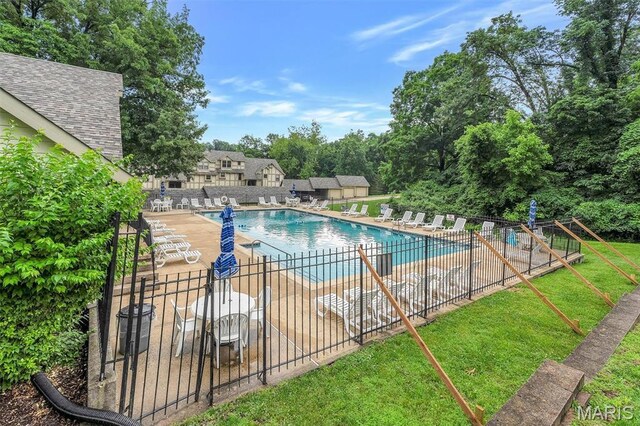 2303 Yosemite Park Ct Unit E, Maryland Heights, MO 63043 - community pool featuring a patio area and view of wooded area