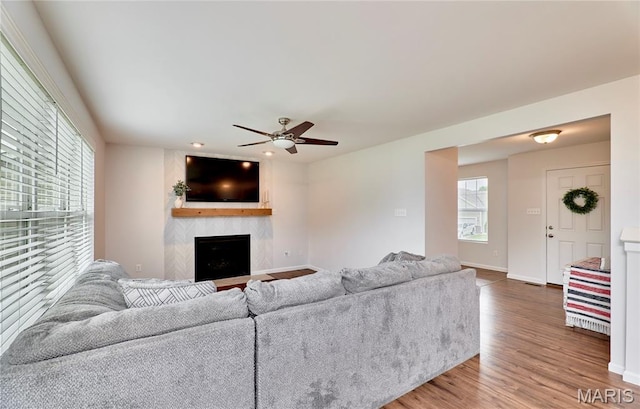 2907 Preston Woods Trl, Lake St Louis, MO 63367 - living room featuring plenty of natural light, wood finished floors, a fireplace, and a ceiling fan