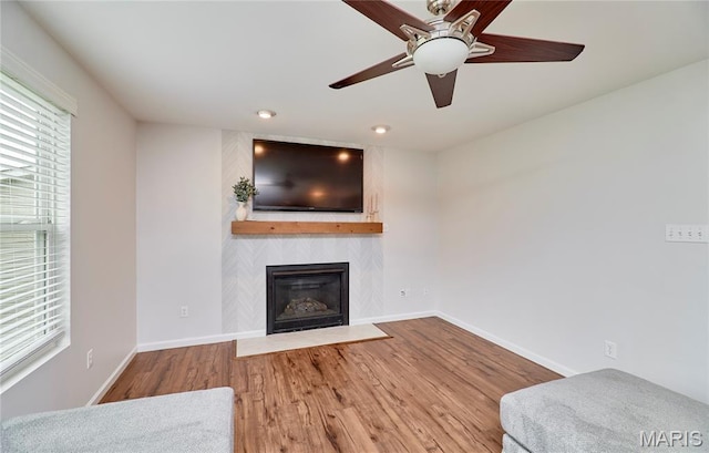 2907 Preston Woods Trl, Lake St Louis, MO 63367 - unfurnished living room with a fireplace, healthy amount of natural light, wood finished floors, a ceiling fan, and recessed lighting