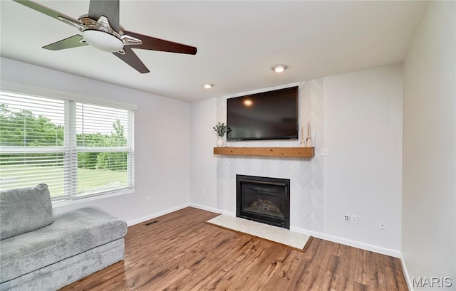 2907 Preston Woods Trl, Lake St Louis, MO 63367 - living area featuring a fireplace, wood finished floors, and a ceiling fan