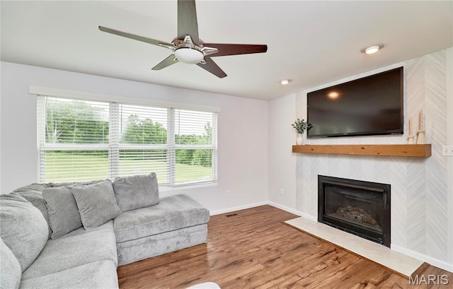2907 Preston Woods Trl, Lake St Louis, MO 63367 - living area with wood finished floors, a ceiling fan, and a fireplace