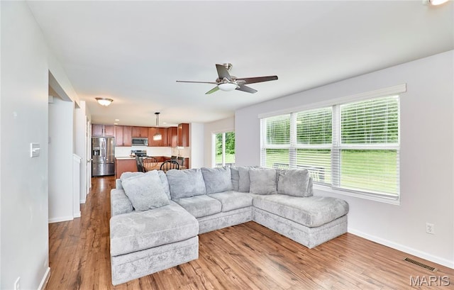 2907 Preston Woods Trl, Lake St Louis, MO 63367 - living room featuring ceiling fan and light wood finished floors