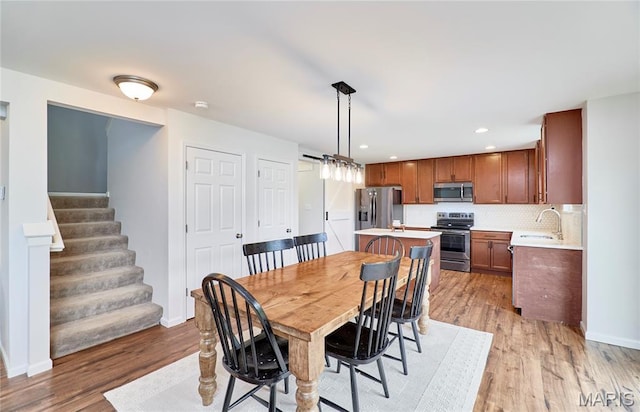 2907 Preston Woods Trl, Lake St Louis, MO 63367 - dining room with light wood-style flooring, stairs, and recessed lighting
