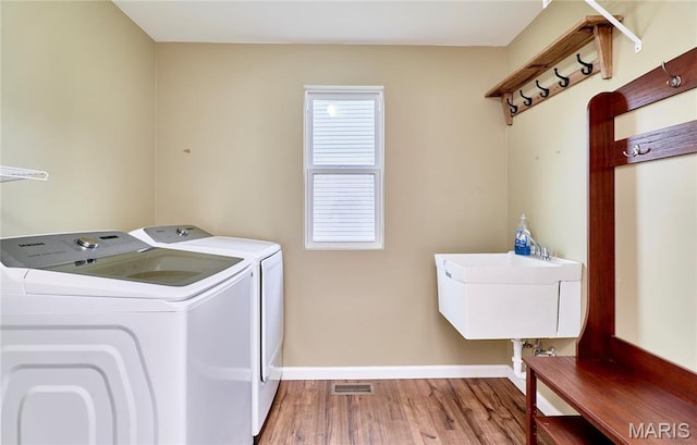2907 Preston Woods Trl, Lake St Louis, MO 63367 - laundry room featuring washing machine and clothes dryer and wood finished floors