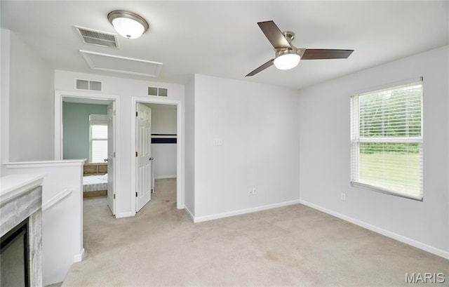 2907 Preston Woods Trl, Lake St Louis, MO 63367 - unfurnished bedroom with attic access, light colored carpet, multiple windows, and ceiling fan