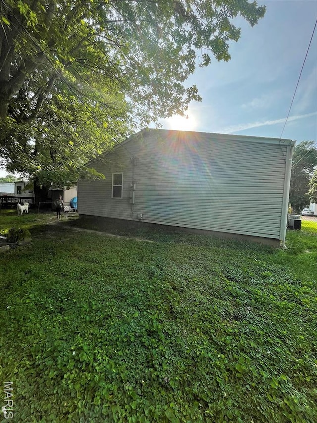 60 La Venta Dr, Florissant, MO 63031 - view of property exterior with a yard and central AC