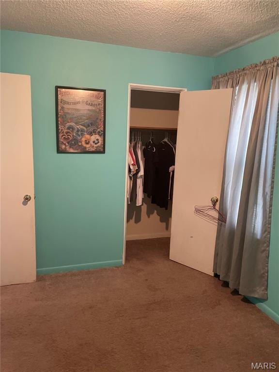 60 La Venta Dr, Florissant, MO 63031 - carpeted bedroom featuring a textured ceiling, a closet, and a walk in closet