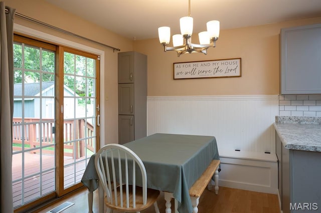9 Donald Dr, Saint Charles, MO 63304 - dining room with a chandelier, wood finished floors, and wainscoting