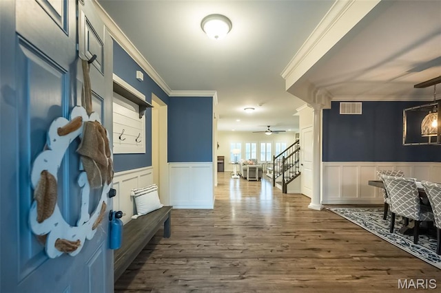 151 Wilmer Valley Dr, Wentzville, MO 63385 - entrance foyer featuring crown molding, a decorative wall, dark wood finished floors, a wainscoted wall, and ornate columns