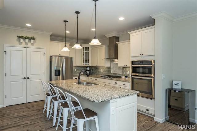 151 Wilmer Valley Dr, Wentzville, MO 63385 - kitchen featuring appliances with stainless steel finishes, a sink, wall chimney exhaust hood, dark wood finished floors, and decorative backsplash