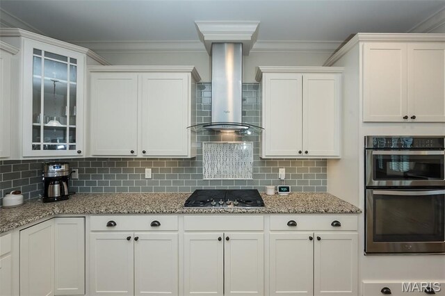 151 Wilmer Valley Dr, Wentzville, MO 63385 - kitchen with appliances with stainless steel finishes, wall chimney exhaust hood, white cabinetry, glass insert cabinets, and ornamental molding
