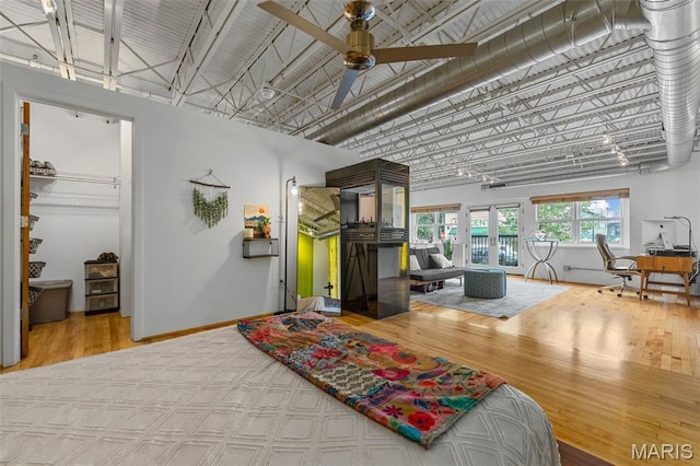 2401 S 12th St Unit 101, Saint Louis, MO 63104 - bedroom with wood finished floors, a high ceiling, access to exterior, a spacious closet, and a ceiling fan