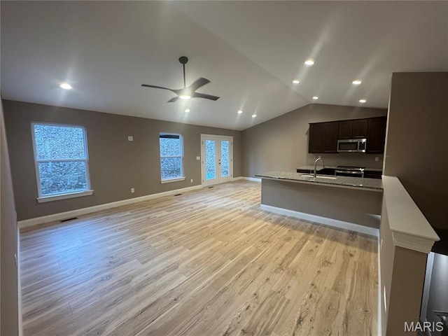 2988 Scott Rd, Moscow Mills, MO 63362 - unfurnished living room with light wood-type flooring, lofted ceiling, ceiling fan, recessed lighting, and baseboards
