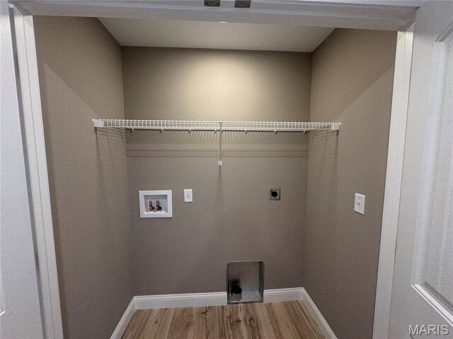 2988 Scott Rd, Moscow Mills, MO 63362 - laundry room with hookup for an electric dryer, baseboards, wood finished floors, and hookup for a washing machine