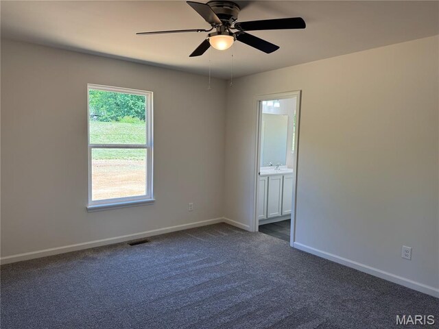 2988 Scott Rd, Moscow Mills, MO 63362 - unfurnished room with a ceiling fan, baseboards, and dark colored carpet