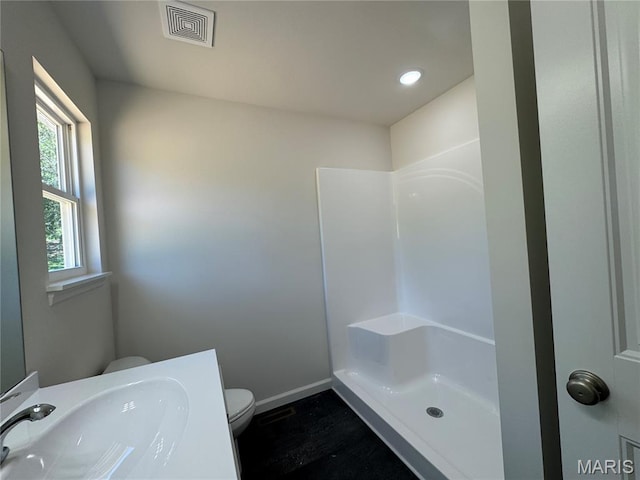 2988 Scott Rd, Moscow Mills, MO 63362 - full bath with toilet, baseboards, wood finished floors, a shower, and recessed lighting