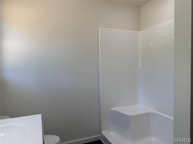 2988 Scott Rd, Moscow Mills, MO 63362 - full bath with toilet, baseboards, vanity, and a shower