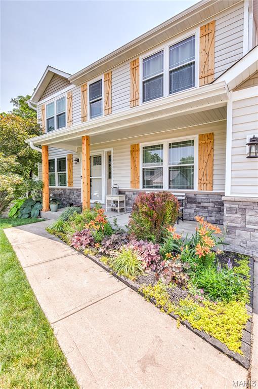 10 Forest Pine Ct, Ofallon, MO 63368 - view of front facade featuring stone siding and a porch