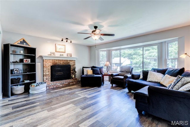 10 Forest Pine Ct, Ofallon, MO 63368 - living area featuring ceiling fan, wood finished floors, and a fireplace