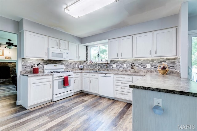 10 Forest Pine Ct, Ofallon, MO 63368 - kitchen featuring white appliances, light wood finished floors, tasteful backsplash, and white cabinets