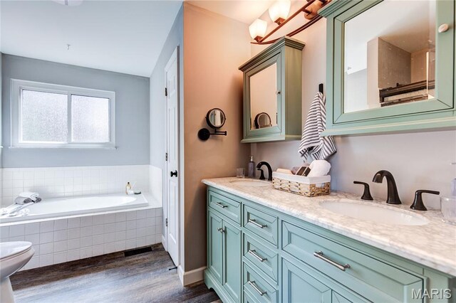 10 Forest Pine Ct, Ofallon, MO 63368 - bathroom with wood finished floors, double vanity, and a garden tub