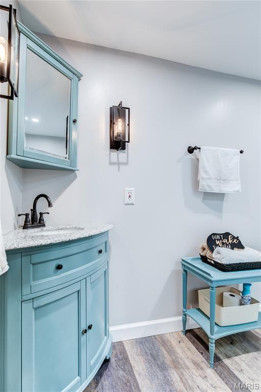 10 Forest Pine Ct, Ofallon, MO 63368 - bathroom featuring wood finished floors and vanity