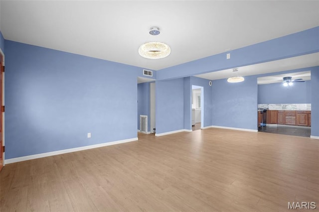 508 Prince Ruppert Dr, Ofallon, MO 63366 - unfurnished living room with wood finished floors, a ceiling fan, and baseboards