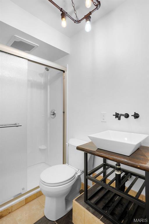 508 Prince Ruppert Dr, Ofallon, MO 63366 - bathroom with a stall shower, a sink, toilet, and tile patterned flooring