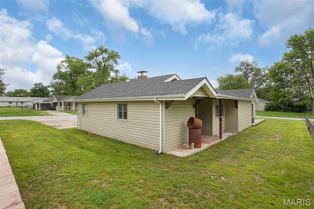 508 Prince Ruppert Dr, Ofallon, MO 63366 - view of side of property with a yard, a shingled roof, and a chimney