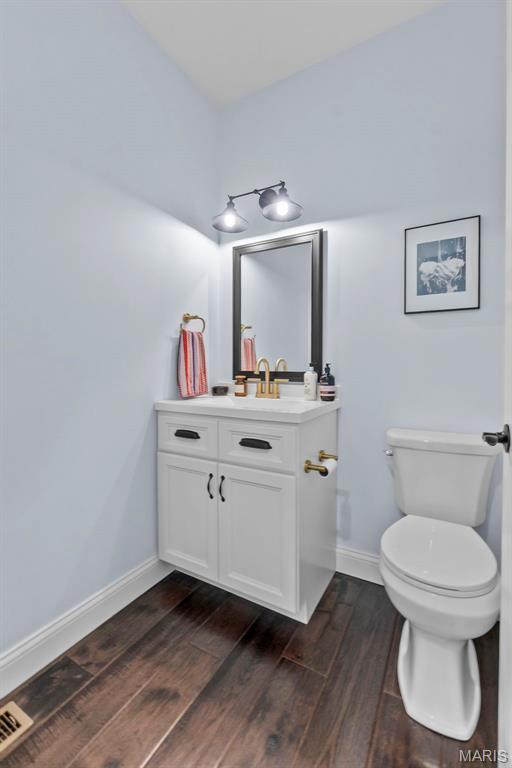 2291 Cambridge, Jackson, MO 63755 - bathroom featuring vanity, toilet, baseboards, and wood finished floors