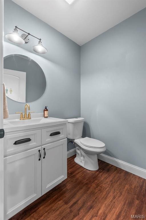 2291 Cambridge, Jackson, MO 63755 - half bath featuring toilet, vanity, wood finished floors, and baseboards