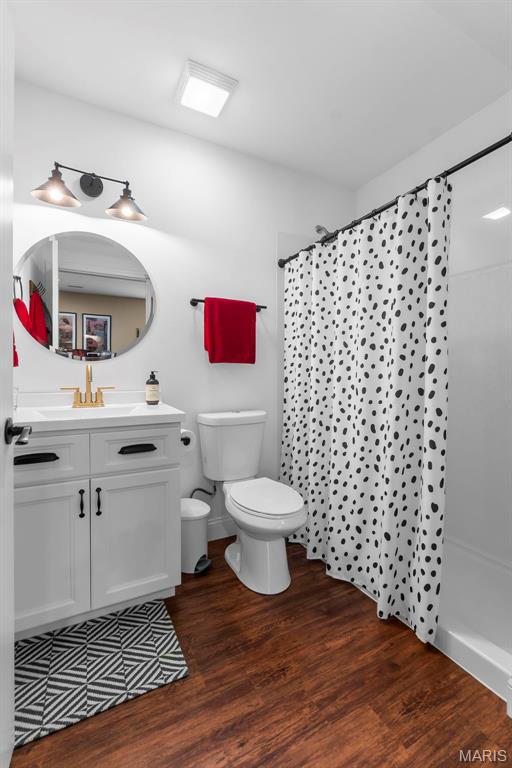 2291 Cambridge, Jackson, MO 63755 - full bathroom featuring toilet, vanity, wood finished floors, and curtained shower