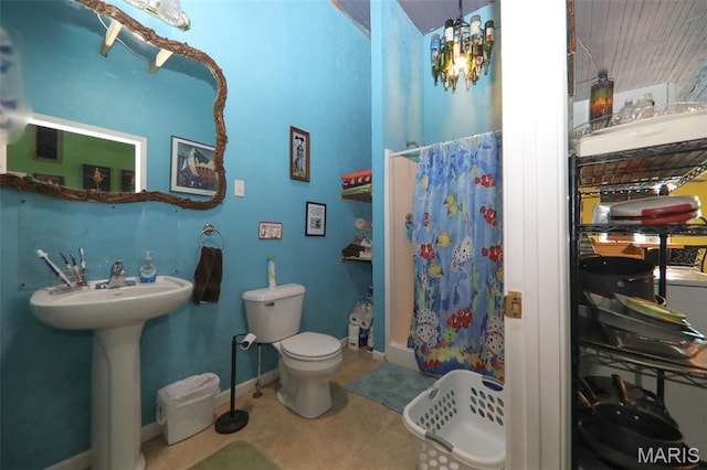 607 Main St, Keyesport, IL 62253 - full bath featuring a shower with curtain, toilet, tile patterned floors, baseboards, and a sink