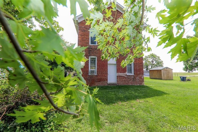 607 Main St, Keyesport, IL 62253 - view of property exterior featuring brick siding and a lawn