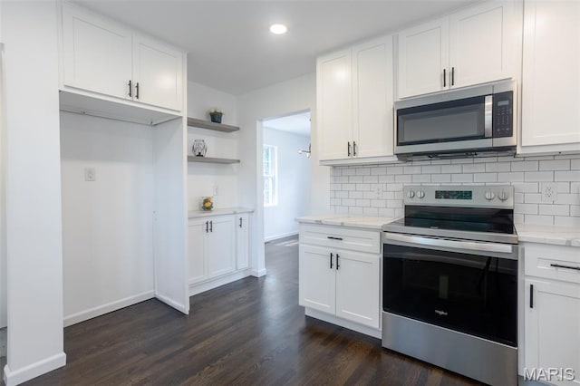 702 Crompton Ct, Saint Louis, MO 63126 - kitchen featuring appliances with stainless steel finishes, backsplash, dark wood-style flooring, white cabinets, and recessed lighting