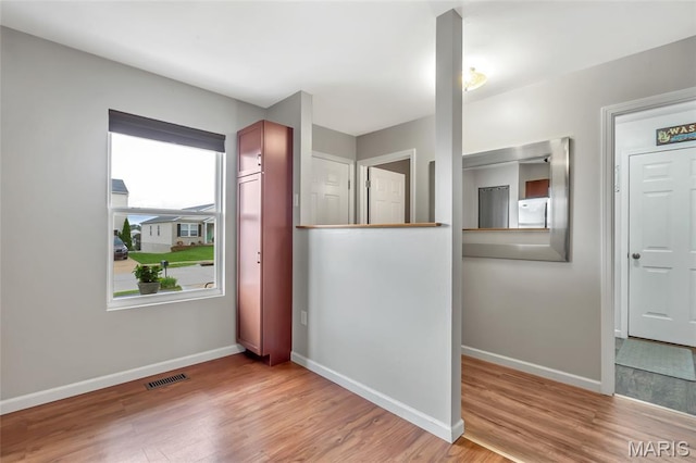 220 Preserve Park Pl, Wentzville, MO 63385 - unfurnished bedroom featuring freestanding refrigerator and wood finished floors